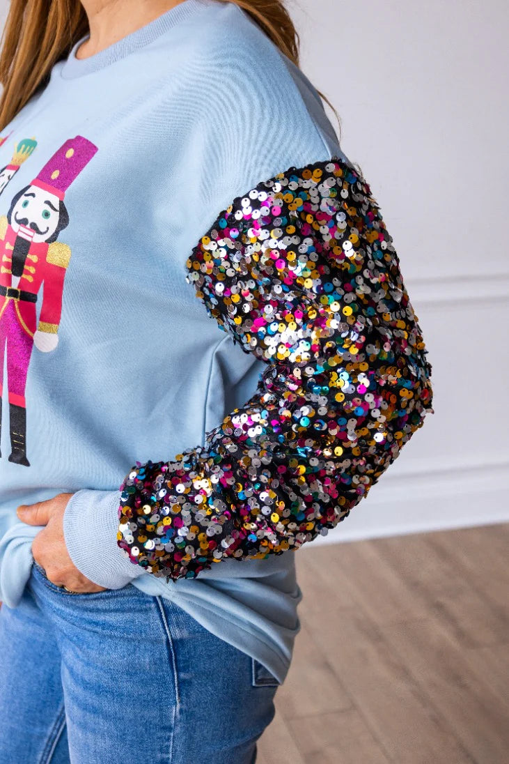 NUTCRACKERS ON BLUE SWEATSHIRT WITH SEQUIN SLEEVES