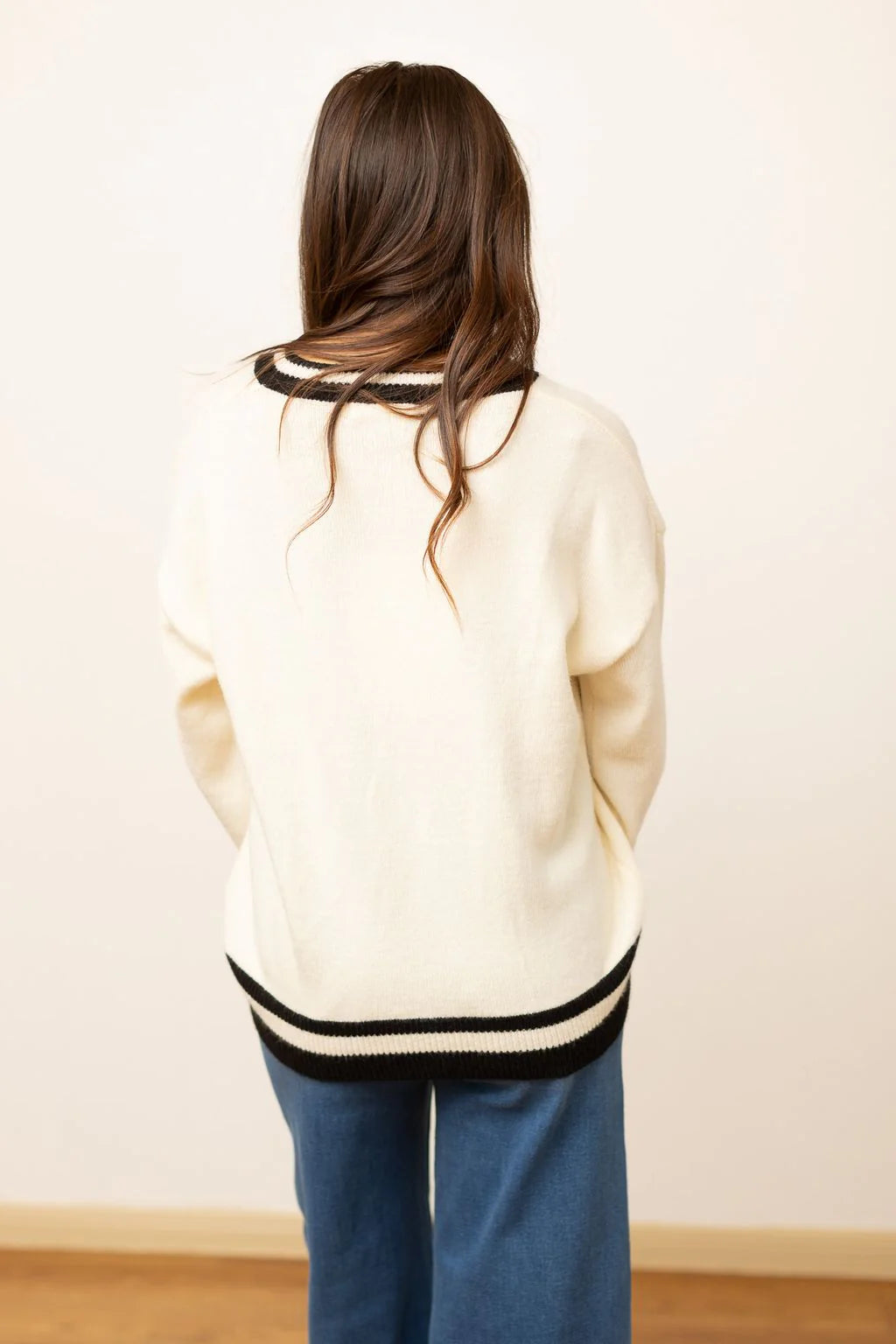 SILVER SEQUIN BOW ON CREAM VARSITY SWEATER