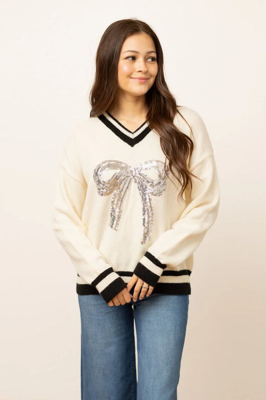 SILVER SEQUIN BOW ON CREAM VARSITY SWEATER